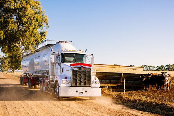 Truck delivers Reid Stockfeeds feed on farm site.